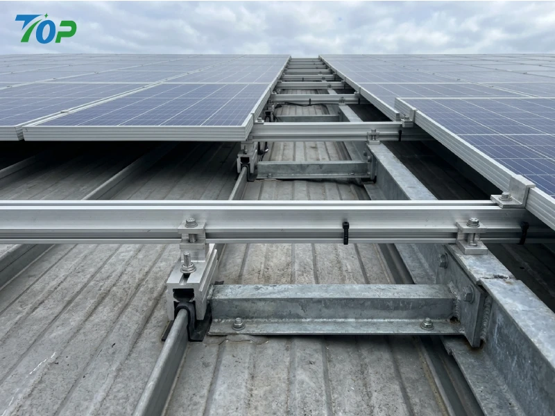 Structural load path of standing seam rooftop solar mounting rails with anti-corrosion clamps
